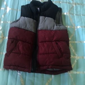 This is a vest that is maroon gray and black.